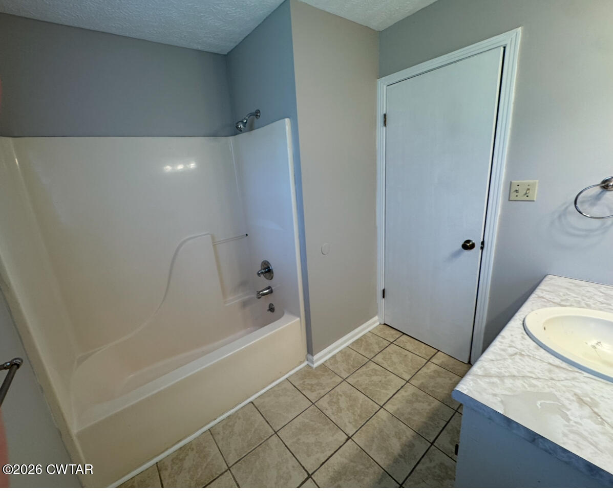 45 Ellendale Cove Jackson, TN 38305 - Photo 13 of 22 a bathroom with a sink and a shower