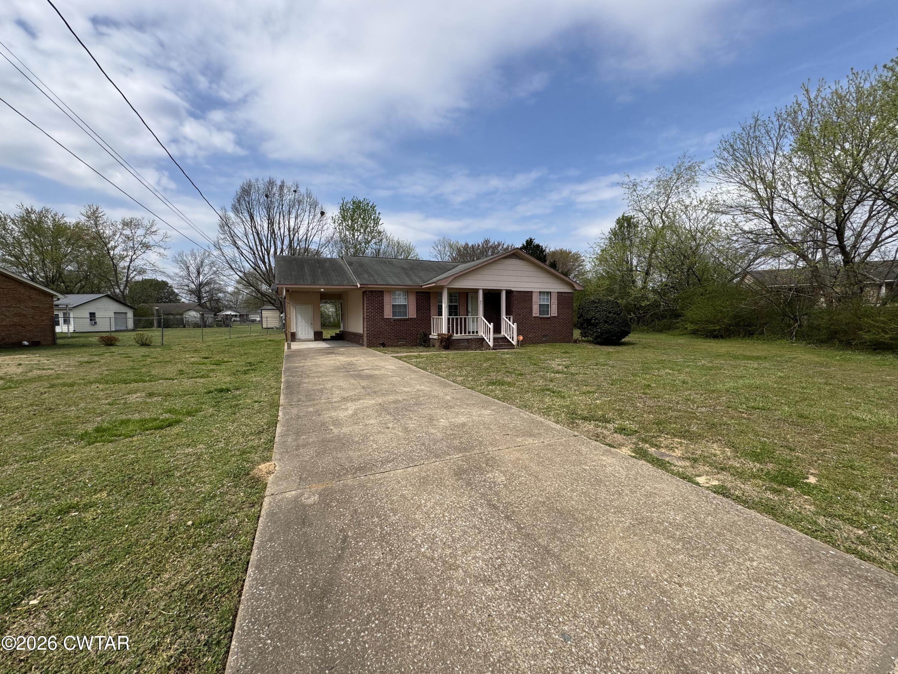 45 Ellendale Cove Jackson, TN 38305 - Photo 14 of 22 a view of a house with a big yard and large trees