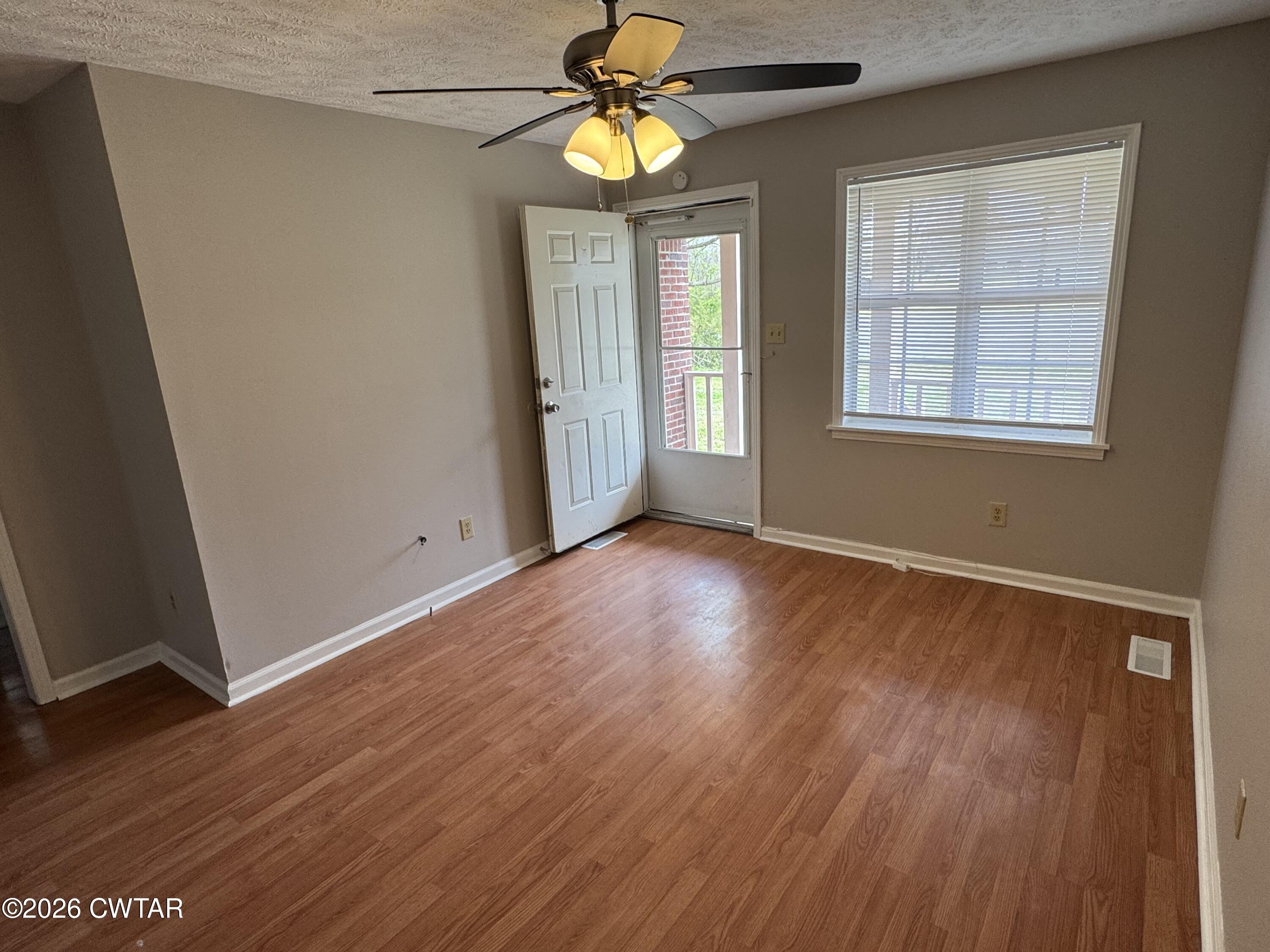 45 Ellendale Cove Jackson, TN 38305 - Photo 4 of 22 a view of an empty room with wooden floor and a window