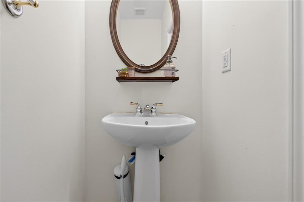 3210 Warbler Way Cumming, GA 30041 - Photo 18 of 45 a bathroom with a sink and a mirror
