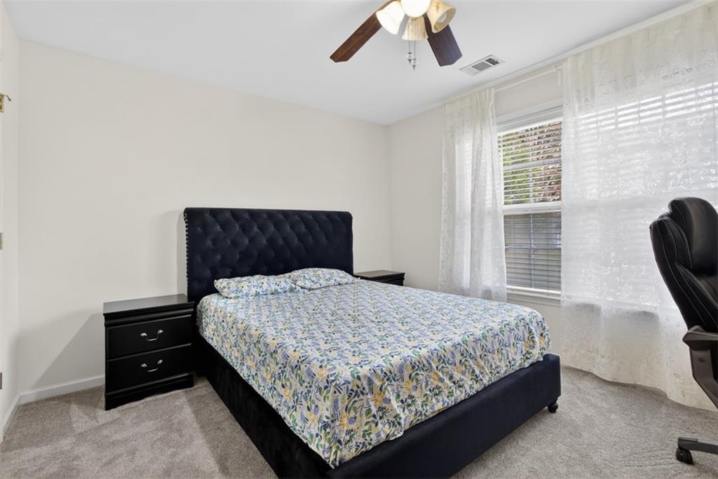 3210 Warbler Way Cumming, GA 30041 - Photo 20 of 45 a bedroom with a bed and window