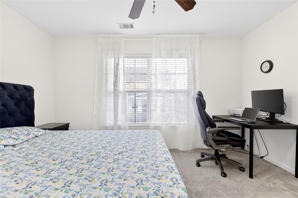 3210 Warbler Way Cumming, GA 30041 - Photo 21 of 45 a bedroom with a workspace