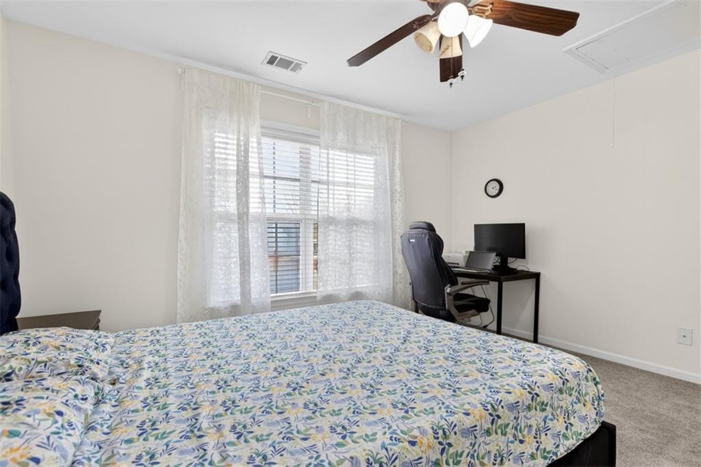 3210 Warbler Way Cumming, GA 30041 - Photo 22 of 45 a bedroom with a bed and a window