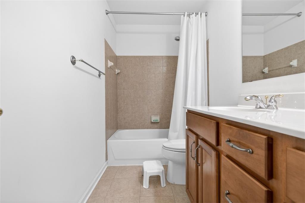 3210 Warbler Way Cumming, GA 30041 - Photo 23 of 45 a bathroom with a granite countertop sink toilet and shower