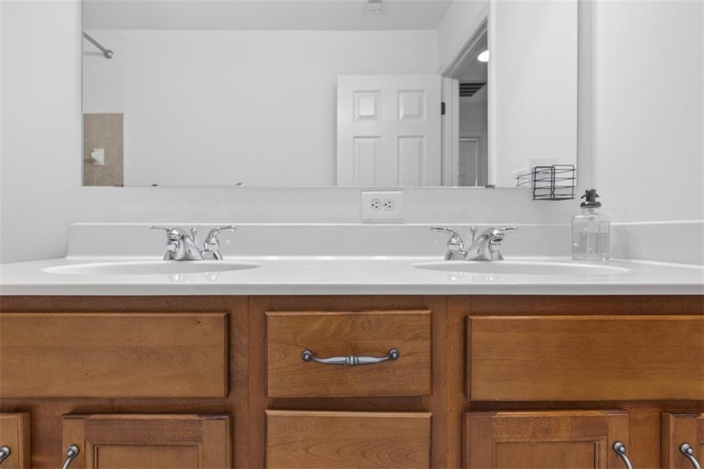 3210 Warbler Way Cumming, GA 30041 - Photo 24 of 45 a bathroom with a sink and a mirror