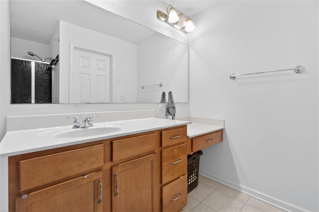 3210 Warbler Way Cumming, GA 30041 - Photo 41 of 45 a bathroom with a sink and a mirror