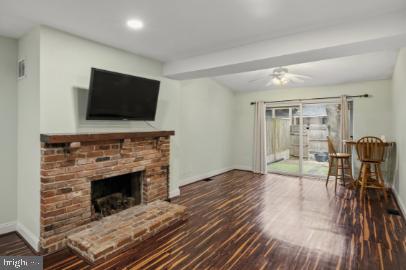 636 Portland Street Baltimore, MD 21230 - Photo 2 of 15 a living room with furniture a flat screen tv and a fireplace