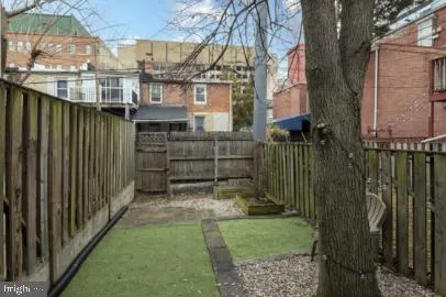 a view of backyard with pathway and a barn