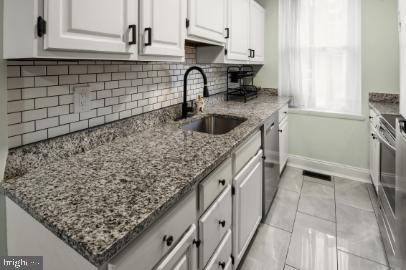 636 Portland Street Baltimore, MD 21230 - Photo 5 of 15 a kitchen with a sink a stove and cabinets