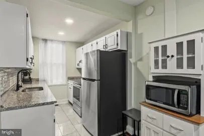 a kitchen with a refrigerator sink and microwave