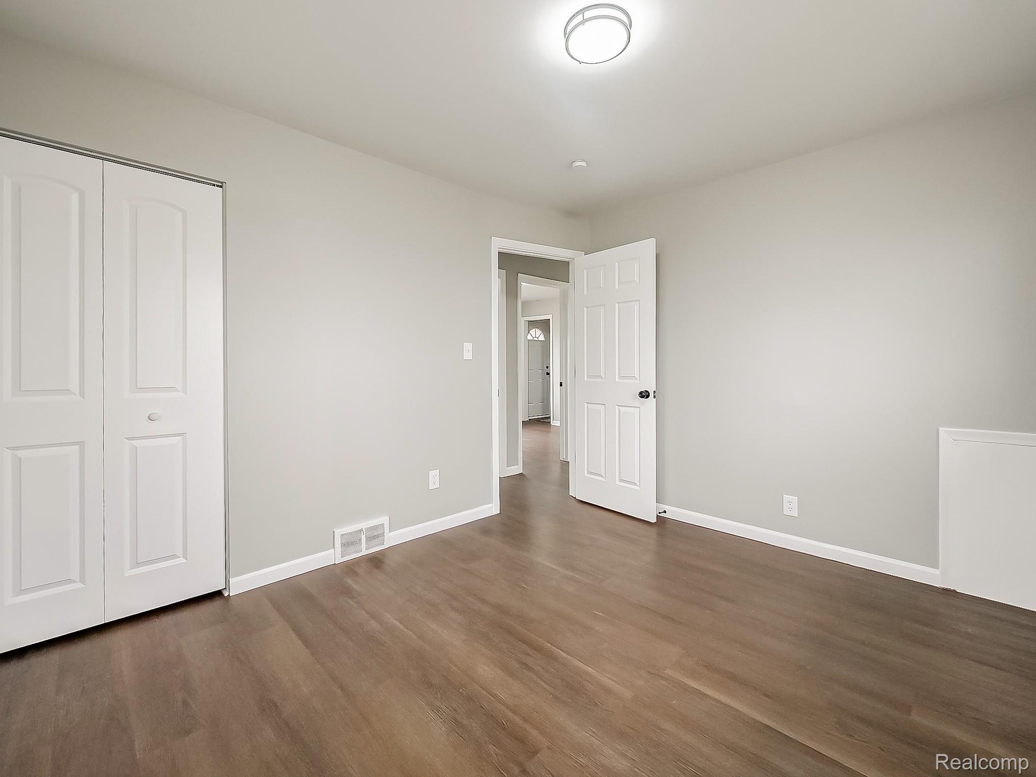 11780 Haggerty Road Belleville, MI 48111 - Photo 15 of 41 Unfurnished bedroom with a closet and dark wood finished floors
