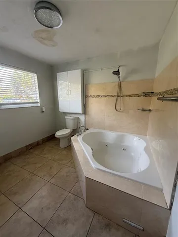 a bath tub sitting next to a white sink