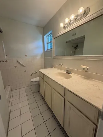 a bathroom with a sink a toilet and mirror