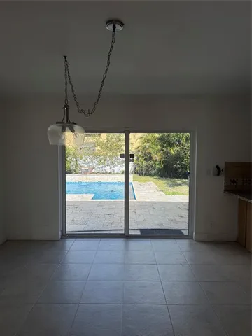 a view of a room with furniture and floor to ceiling window