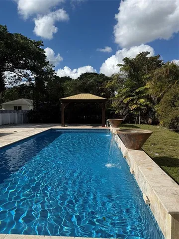 a view of outdoor space with swimming pool and furniture