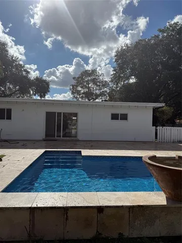a view of a house with backyard space and sitting area
