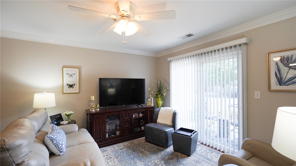 303 Lookover Drive Anderson, SC 29621 - Photo 8 of 46 This inviting living space features elegant crown molding and ample natural light, perfect for relaxation.