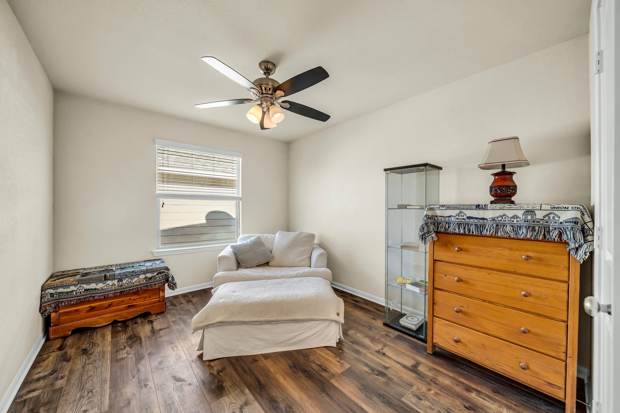 14212 Portrait Court Houston, TX 77045 - Photo 19 of 27 Spacious and bright, this inviting bedroom has a stylish ceiling fan, perfect for relaxation and comfort.
