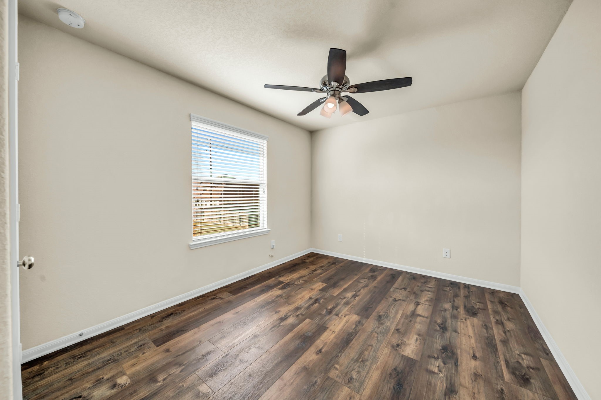 14212 Portrait Court Houston, TX 77045 - Photo 23 of 27 Discover Bedroom 4: a bright, inviting space with a modern ceiling fan, perfect for comfort and style.