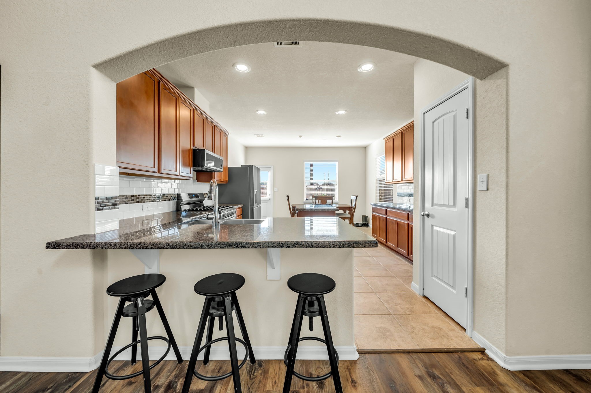 14212 Portrait Court Houston, TX 77045 - Photo 7 of 27 Cozy breakfast bar perfect for casual dining and entertaining.