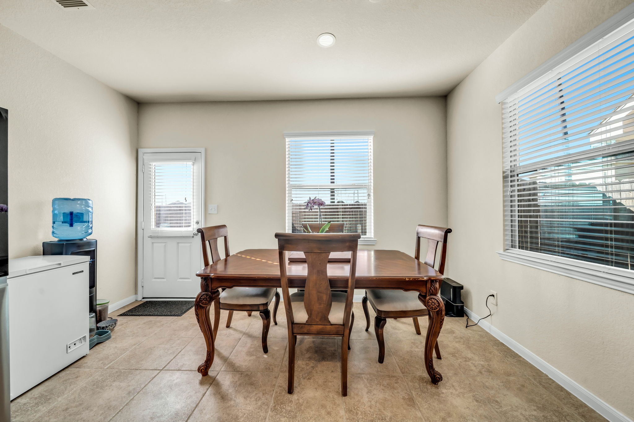 14212 Portrait Court Houston, TX 77045 - Photo 9 of 27 Bright and inviting dining area with ample natural light, perfect for family gatherings.