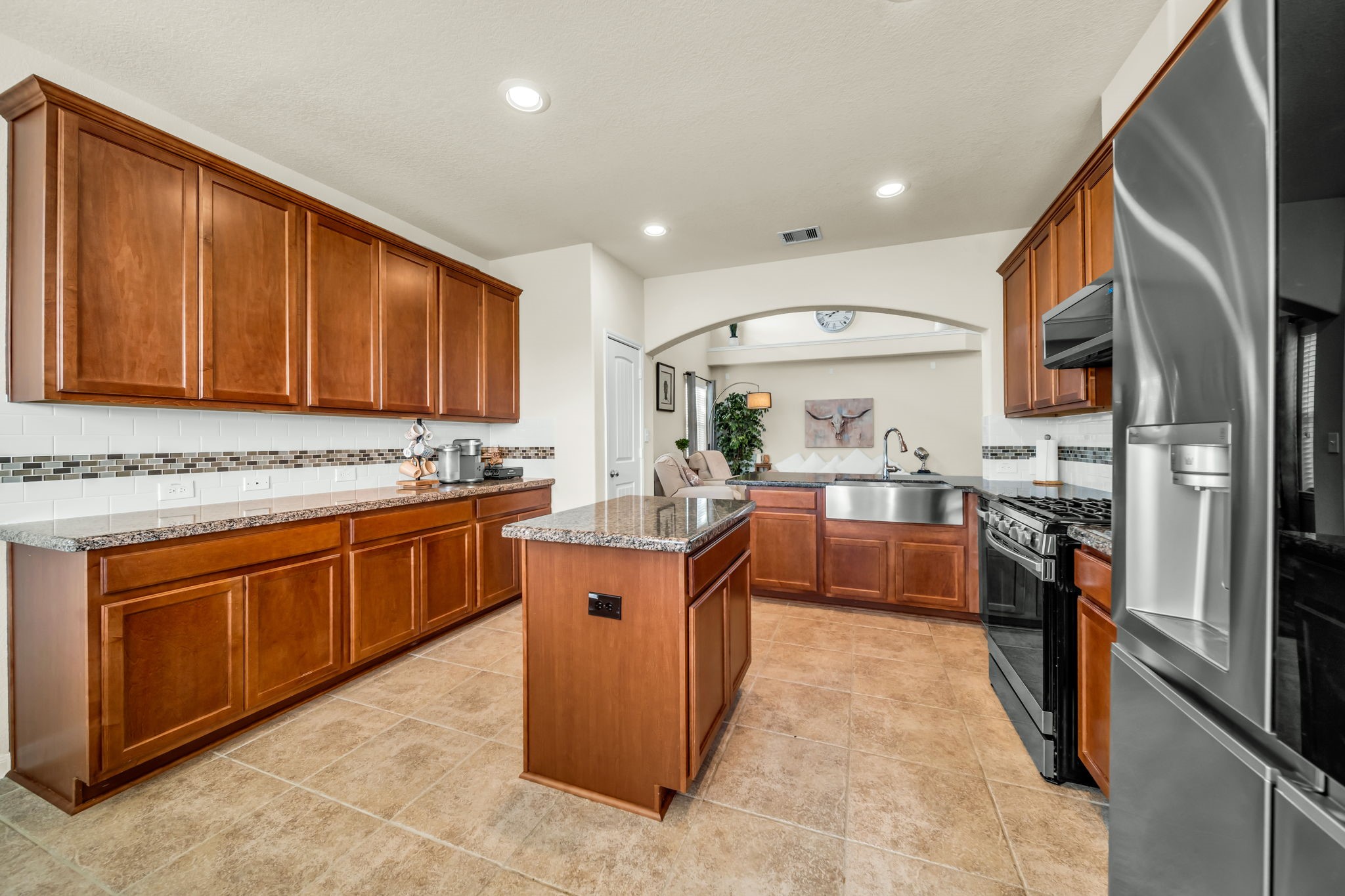14212 Portrait Court Houston, TX 77045 - Photo 10 of 27 Spacious kitchen with a central island, perfect for cooking and entertaining.