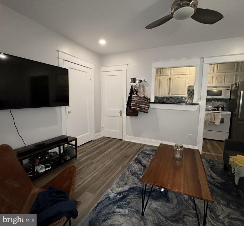 414 Seward Square Southeast, Unit 104 Washington, DC 20003 - Photo 5 of 6 a living room with furniture and a flat screen tv