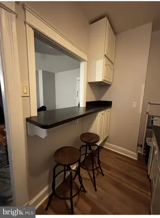 a kitchen with granite countertop a sink a stove and cabinets