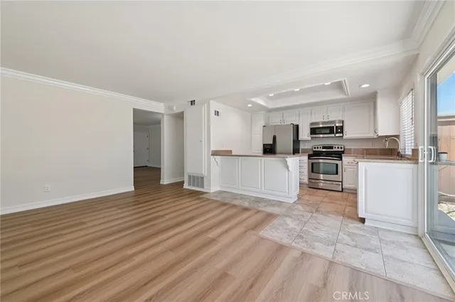 a view of kitchen with microwave and cabinets