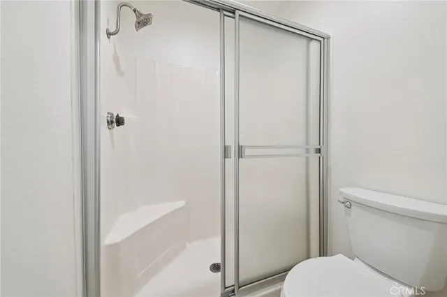 a bathroom with a shower and a toilet