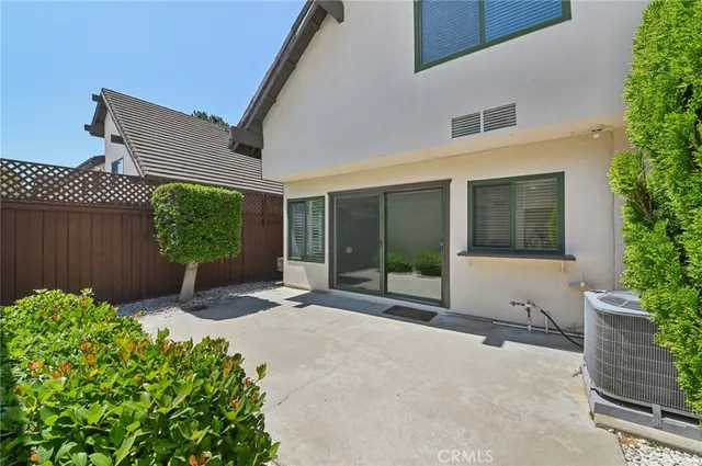 a view of a house with a yard and potted plants