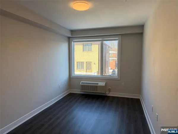 a view of room with window and hardwood floor