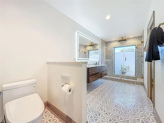 a kitchen with stainless steel appliances wooden cabinets stove and window