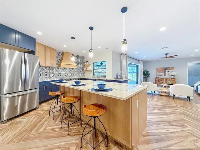 a kitchen with stainless steel appliances granite countertop a sink and cabinets