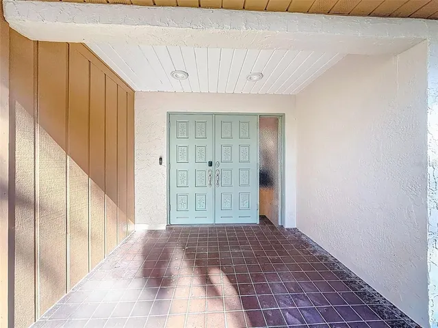a view of a hallway with wooden floor and furniture