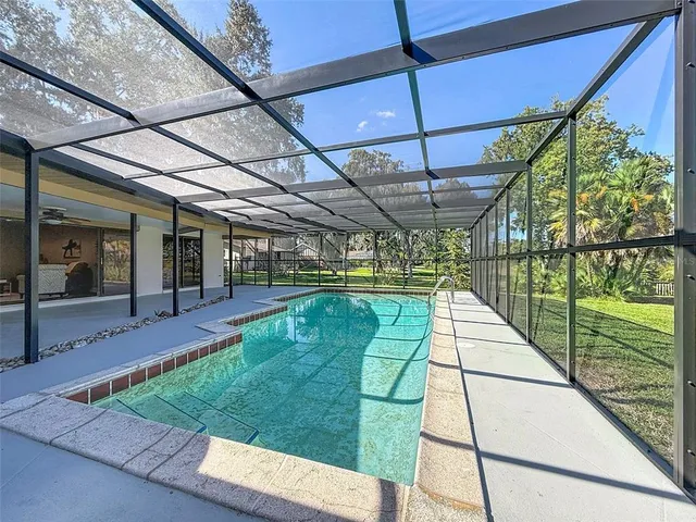 a view of a swimming pool with a yard