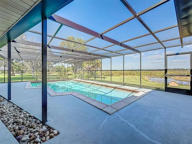 a view of a hallway with a table and chairs