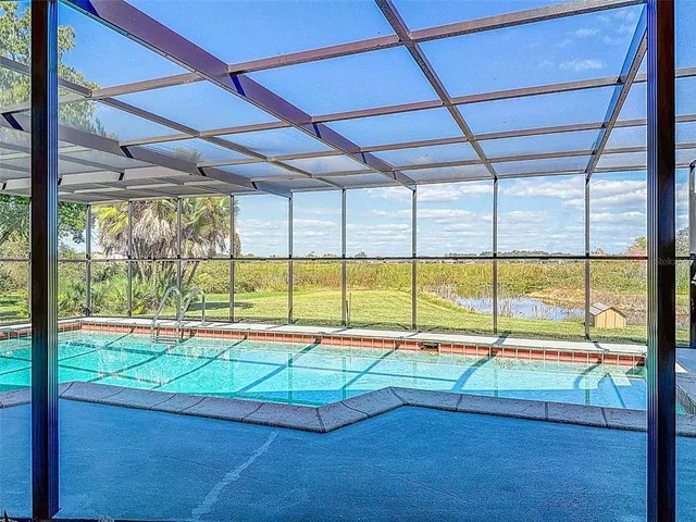a view of a kitchen with a sink and a large window