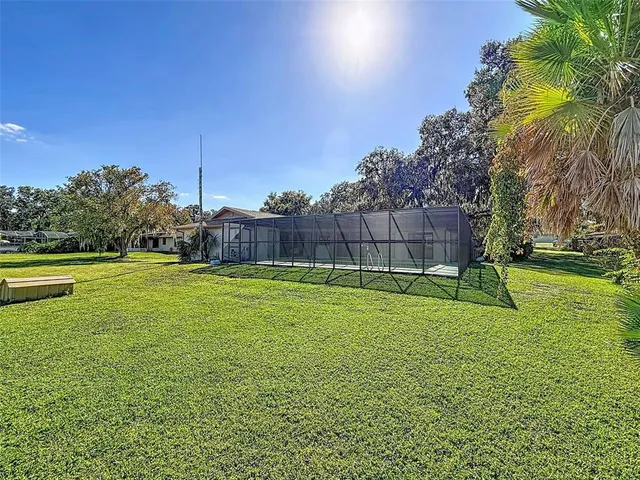 a kitchen with a sink and a stove next to a large window
