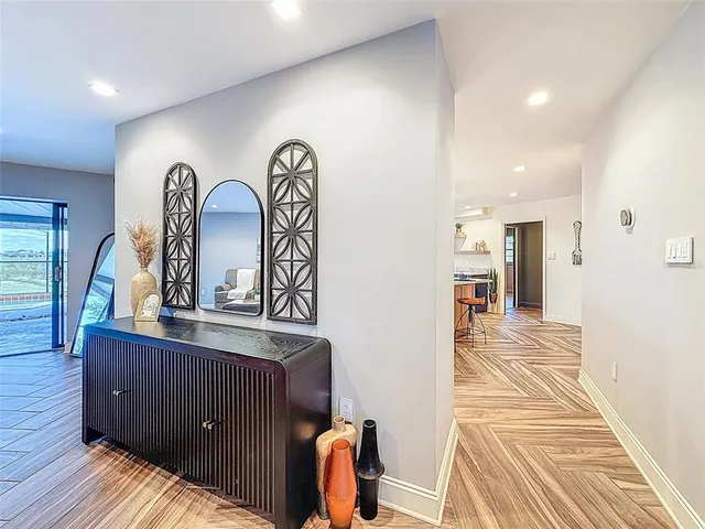 en empty room with windows and ceiling fan