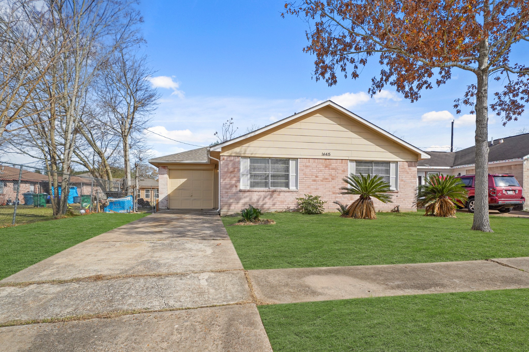 14415 Insley Street Houston, TX 77045 - Photo 1 of 12 a front view of a house with a yard and garage