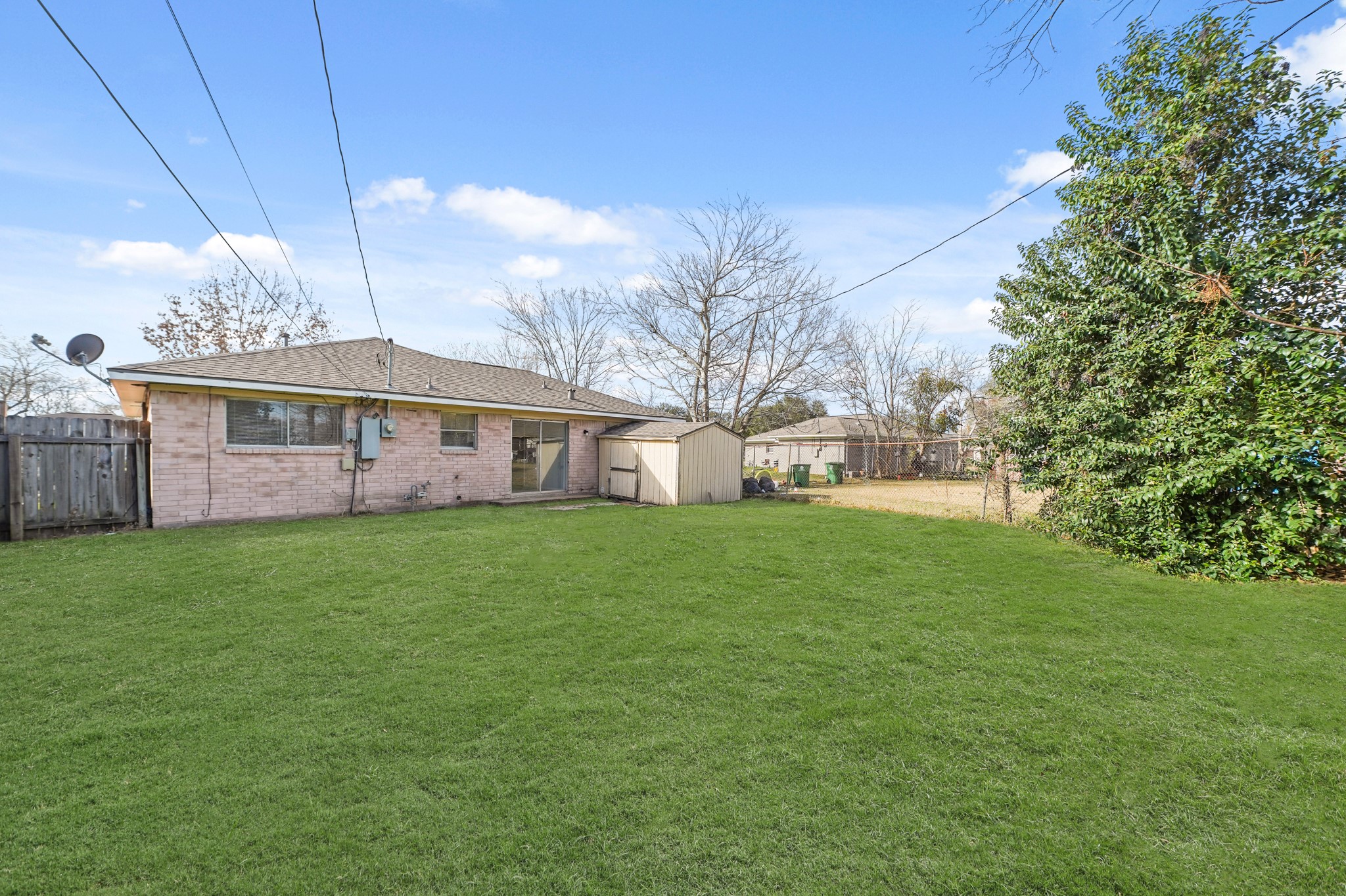 14415 Insley Street Houston, TX 77045 - Photo 11 of 12 a view of a house with a yard