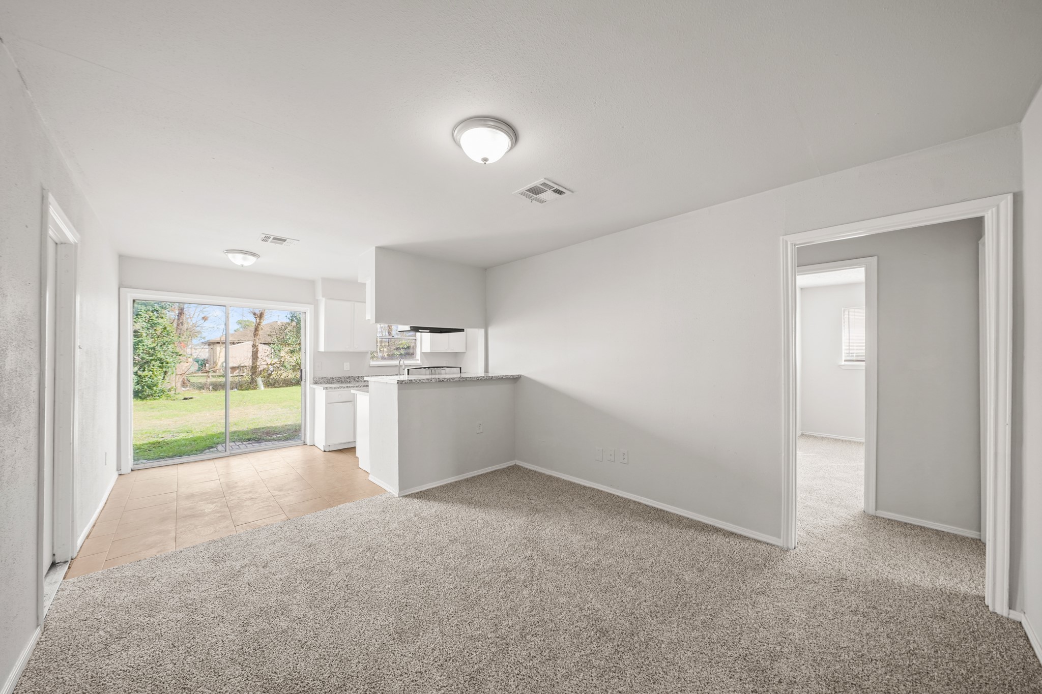 14415 Insley Street Houston, TX 77045 - Photo 2 of 12 a view of a kitchen with refrigerator and windows