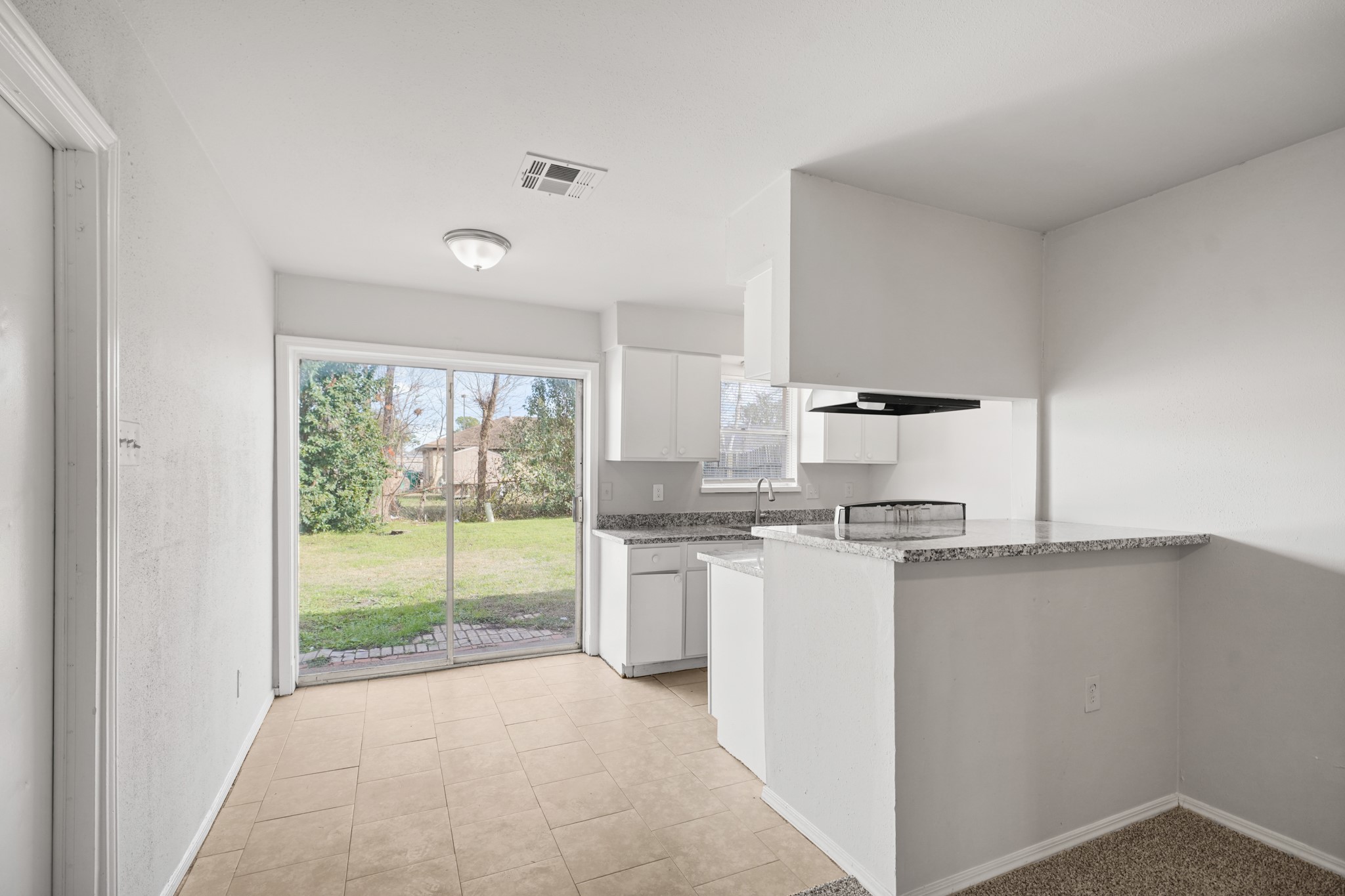 14415 Insley Street Houston, TX 77045 - Photo 3 of 12 a kitchen with stainless steel appliances granite countertop a stove and a refrigerator