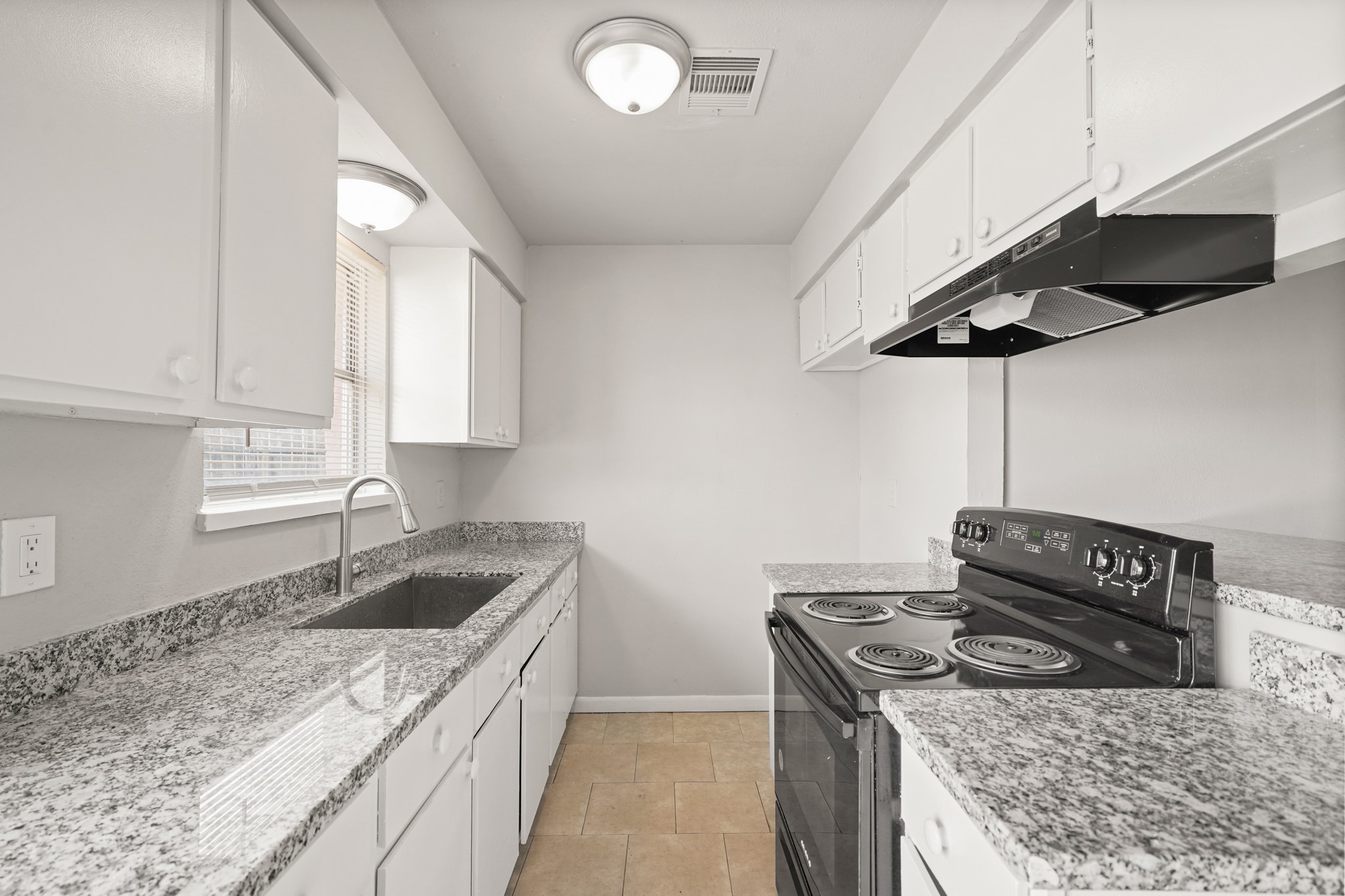 14415 Insley Street Houston, TX 77045 - Photo 4 of 12 a kitchen with stainless steel appliances granite countertop a sink stove and cabinets