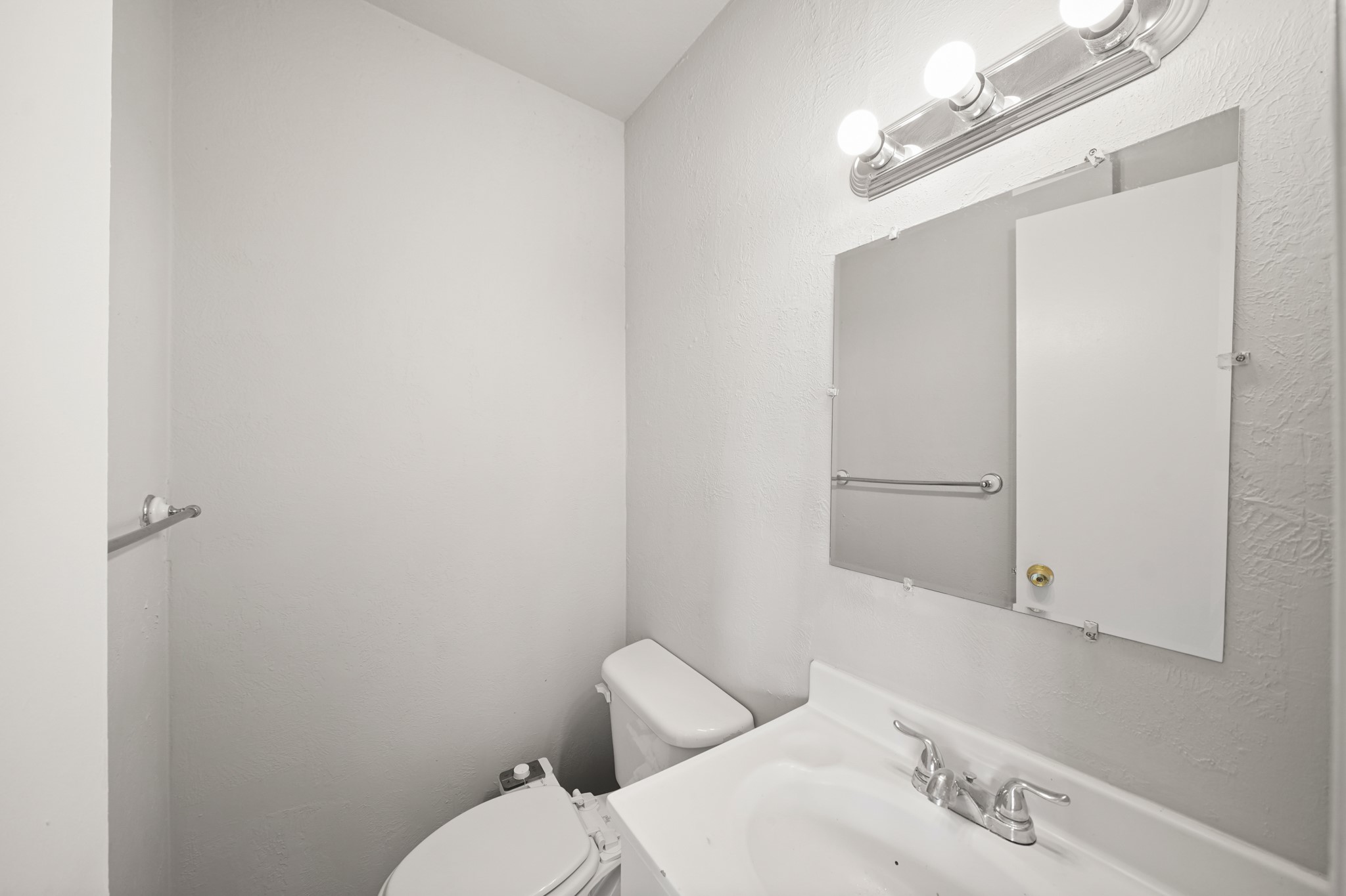 14415 Insley Street Houston, TX 77045 - Photo 7 of 12 a bathroom with a toilet sink and mirror