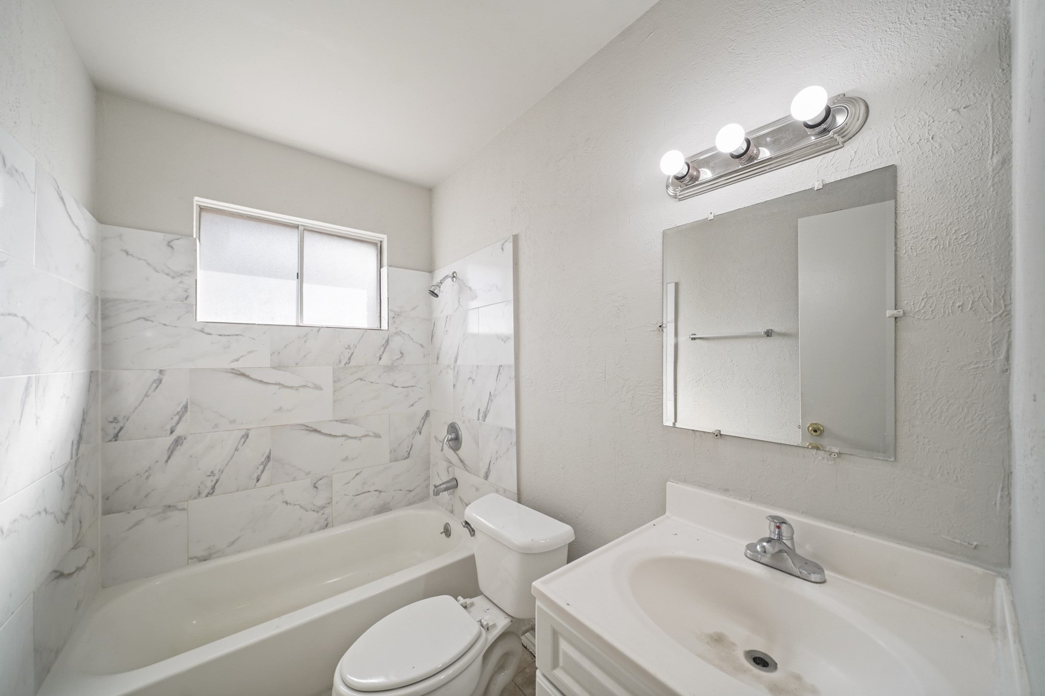 14415 Insley Street Houston, TX 77045 - Photo 10 of 12 a bathroom with a sink a toilet and shower
