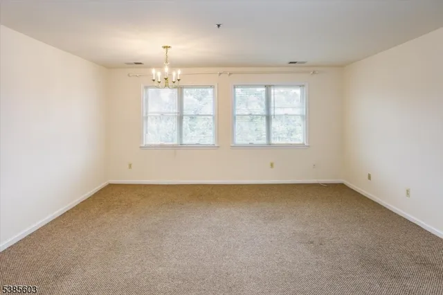 an empty room with a empty space and windows