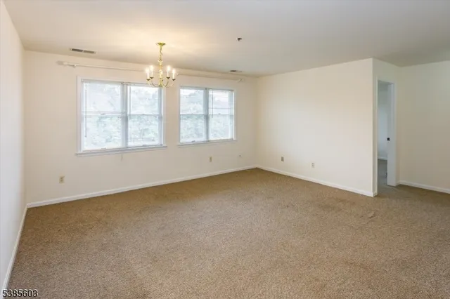 an empty room with a empty space and windows