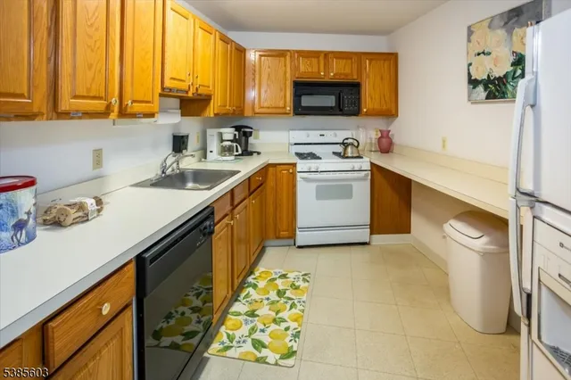 a kitchen with a sink stove and microwave